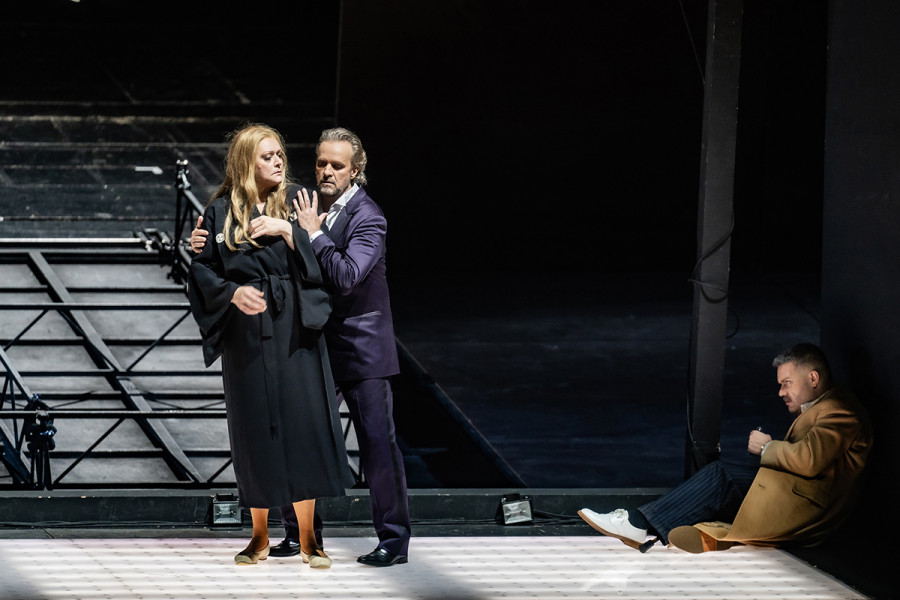 Turandot - © 2023 // Bettina Stöß Hochmütig blickt Turandot auf Calaf, der sie in den Armen hält. Ans rechte Bühnenportal gelehnt, sitzt Timur und beobachtet misstrauisch die Situation.
