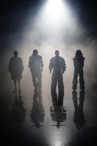 Vier Personen stehen nebeneinander im Gegenlicht. Sie sind nur als Schatten zu erkennen. Auf der Bühne ist Nebel. Vier Personen stehen nebeneinander im Gegenlicht. Sie sind nur als Schatten zu erkennen. Auf der Bühne ist Nebel.