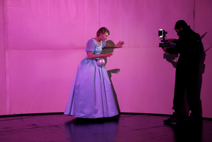 Eine Schauspielerin liest einen Brief. Vor ihr steht ein Kameramann, der sie dabei filmt. Eine Schauspielerin liest einen Brief. Vor ihr steht ein Kameramann, der sie dabei filmt.