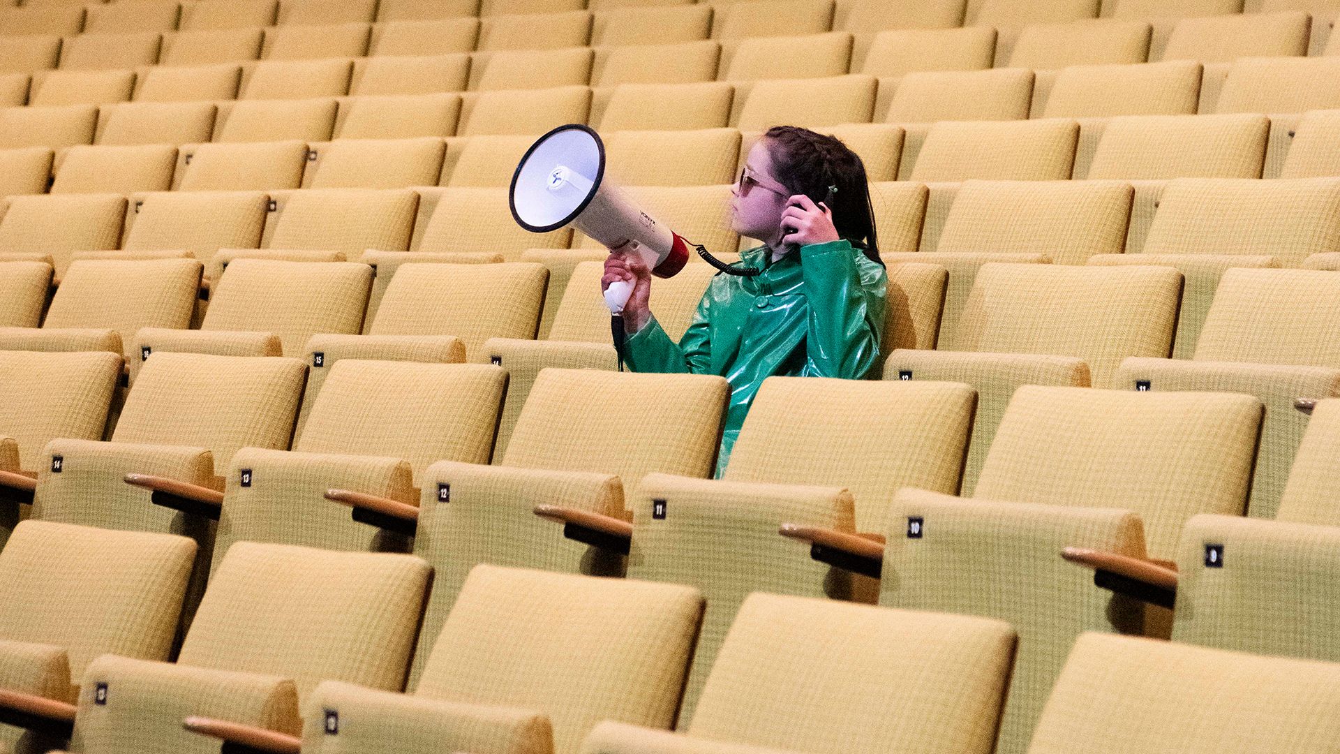 Junge Deutsche Oper  | Hier geht es zur Website der Jungen Deutschen Oper Ein Kind mit Megaphon sitzt in den ansonsten leeren Reihen unseres Parketts.